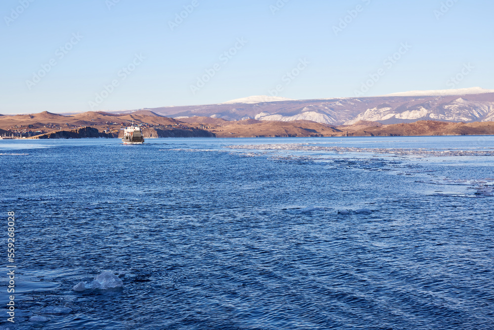 Lake Baikal. The ferry transports passengers from Olkhon Island to the mainland. Ice floes in the lake.
