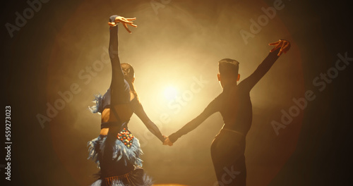 Two little asian ballroom dancers performing some latin dance. Young talented choreographers showing art - childhood dream, childhood memories concept 