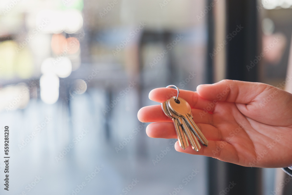 Closeup image of a hand holding the keys for real estate concept