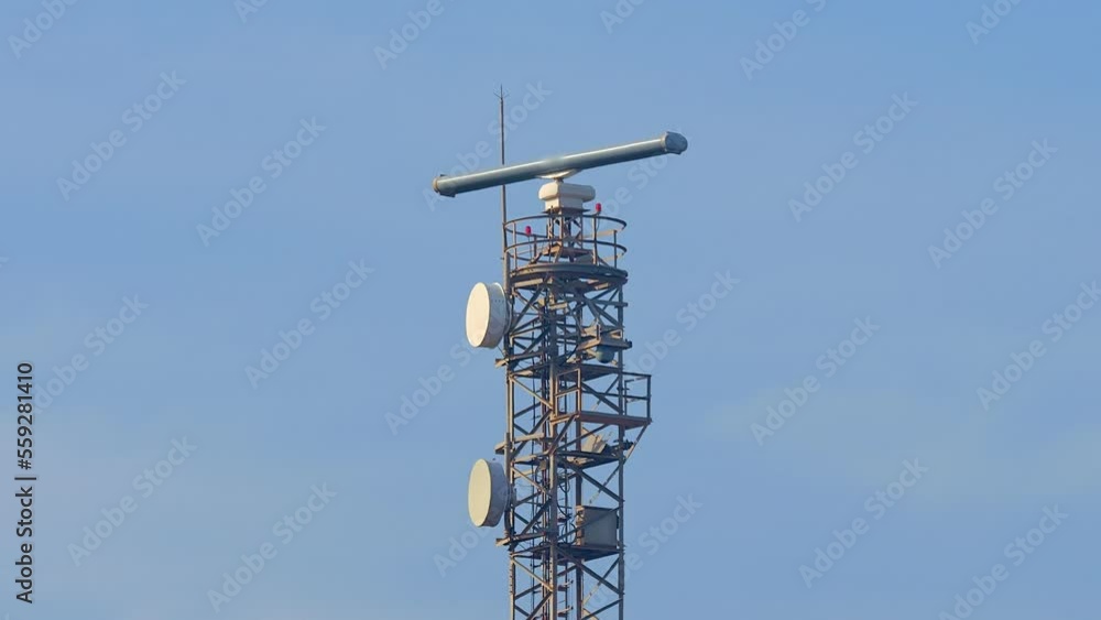Radar Tower Beacon against a blue sky on a sunny day. Metal truss construction. Radar Tower Beacon against a blue sky on a sunny day. Metal truss construction.