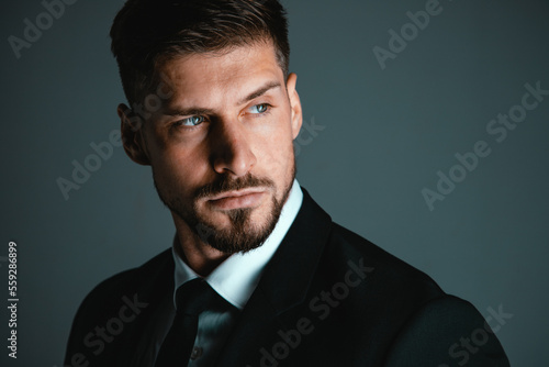 Portrait of a young and handsome model in a classic black and white style clothing. Studio shot. Copy space.