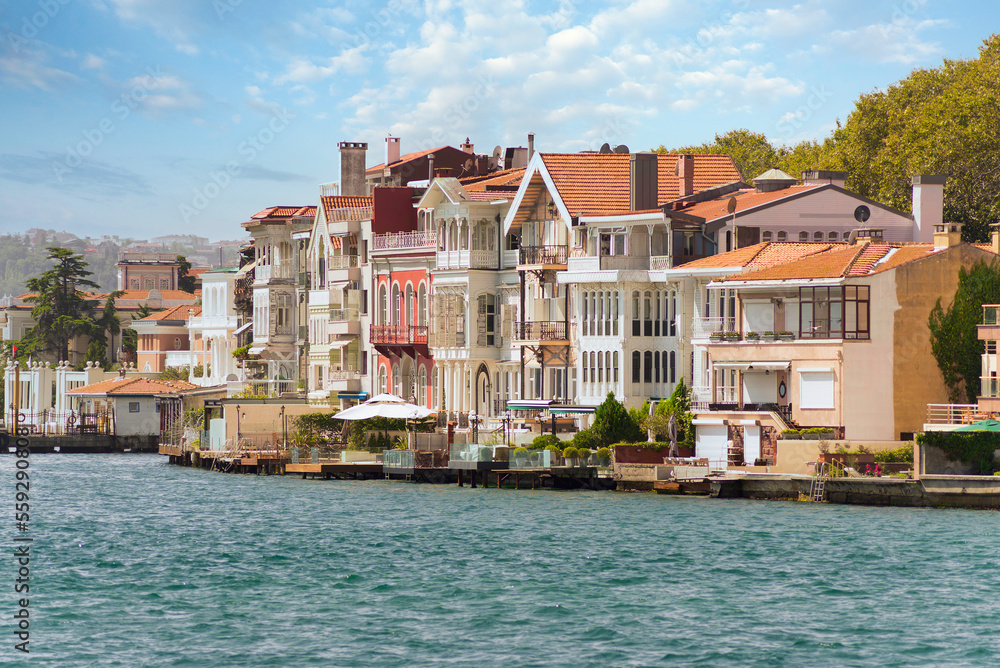 Obraz premium View from the sea of the European side of Bosphorus strait, Istanbul, Turkey, with traditional houses, in a summer day
