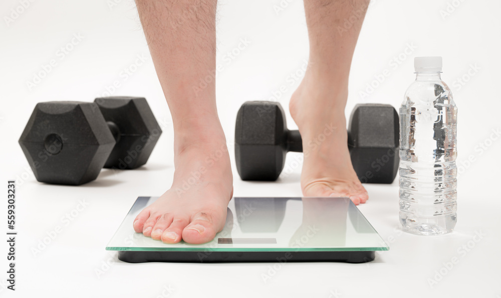 Fototapeta premium Asian middle-aged man's feet measuring weight