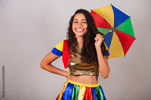Beautiful black Brazilian woman, with frevo outfit, and umbrella, carnival. photo