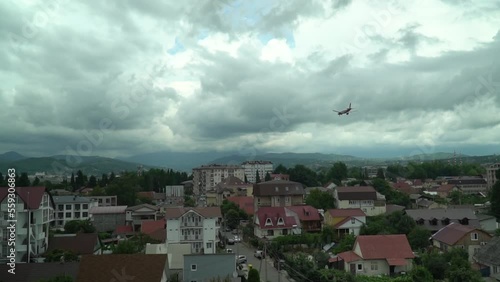 Plane in Adler comes to land visible roofs of houses