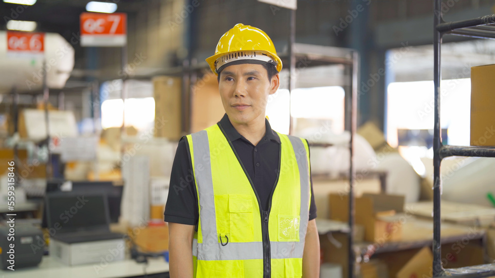 Portrait of Asian man worker working in large warehouse retail store industry factory. Rack of stock storage. Cargo in ecommerce and logistic concept. Depot. People lifestyle. Shipment service. Portrait of Asian man worker working in large warehouse retail store industry factory. Rack of stock storage. Cargo in ecommerce and logistic concept. Depot. People lifestyle. Shipment service.