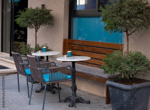 Empty table in outdoor cafe or restaurant. Tables and chairs at sidewalk cafe.