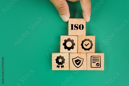wooden square with ISO certificate icon, certified, standardization, warranty, control, quality. Quality control certification and standardization. International standards quality assurance concept photo