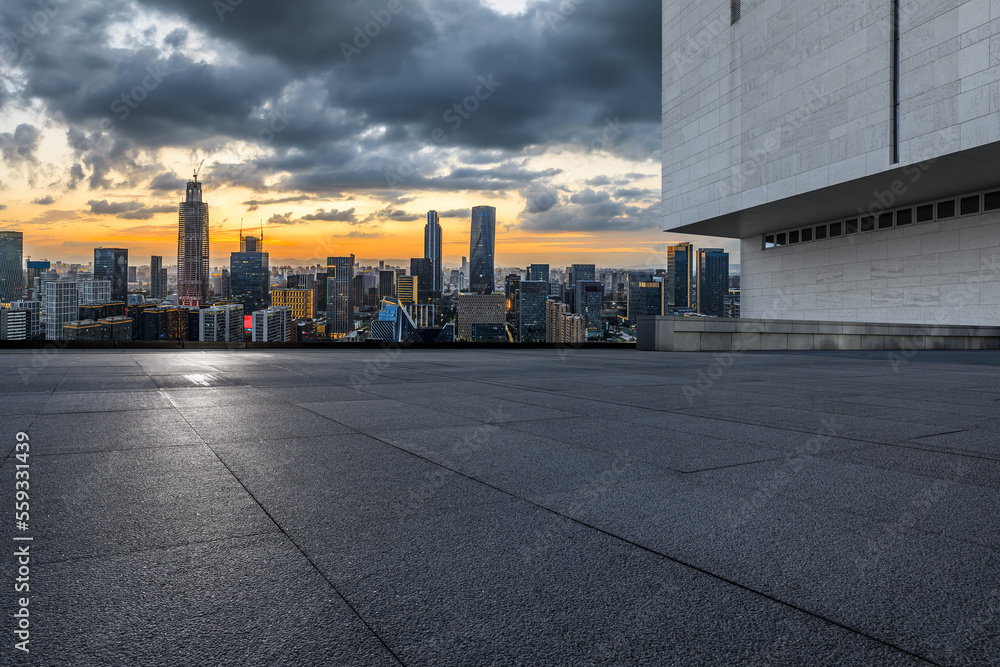 Empty square floor and modern city skyline with buildings at sunset in Ningbo, Zhejiang Province, China.  