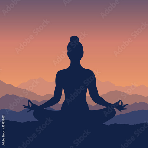 Silhouette of a woman in lotus pose meditating at sunrise 
