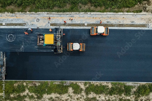 Schilderij op canvas Aerial view of construction site is laying new asphalt pavement