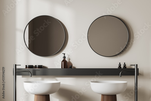 Light bathroom interior with washbasins and mirror  accessories on shelf