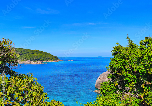 Blue tropical sea with islands on which green trees grow. For travel companies.