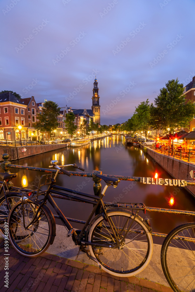 evening view on prinsengracht in amsterdam from leliesluis with westkerk in background