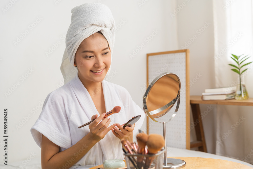 Happy beauty blogger concept, cute asian young woman, girl smile, make up face by applying brush blush powder on her cheek, looking at the mirror. People look with natural fashion style. Happy beauty blogger concept, cute asian young woman, girl smile, make up face by applying brush blush powder on her cheek, looking at the mirror. People look with natural fashion style.