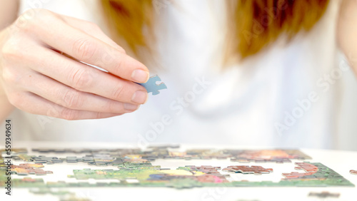 the girl collects puzzles in close-up