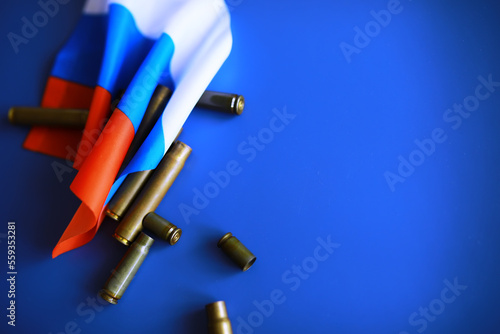 Russian flag and bullet casings on the table. Background concept Russian army.