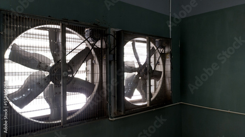 Close-up of big industrial Exhaust fan in a factory. Ventilation of plant building. 