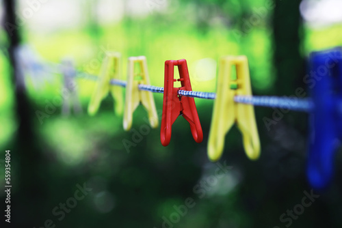 Dry clothes outside. Clothes on a rope. Clothespins on a clothesline in summer.