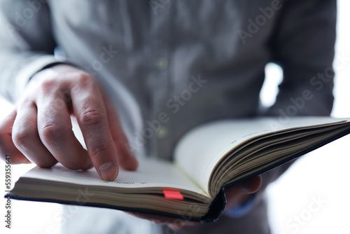 Read book. A man sits and reads literature. Textbooks to study. Religion.