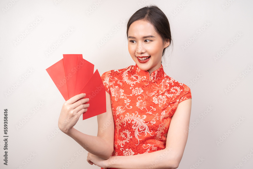 Chinese new year festival celebrate culture of china people, cheerful asian young woman, girl hand holding red envelope, wearing red cheongsam dress traditional. Isolated on white background. Chinese new year festival celebrate culture of china people, cheerful asian young woman, girl hand holding red envelope, wearing red cheongsam dress traditional. Isolated on white background.