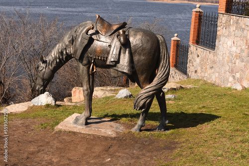 Keleberda, Poltava region, Ukraine - March 29, 2021: Horse statue on the bank photo