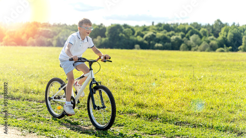 loving mother help her cute son ride a bicycle