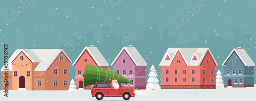 Winter snowy urban landscape with red car, Santa Claus driving and Christmas tree on top. Snow city decorated with festive garlands among snowdrifts and fir trees.