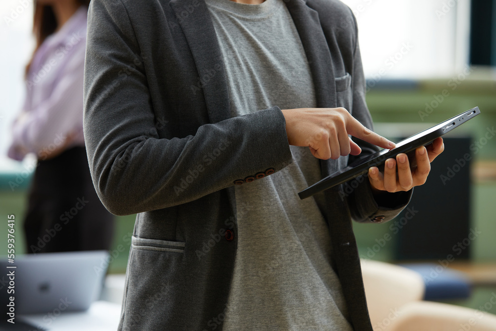 close up businessman holding and using a tablet on hands in the office