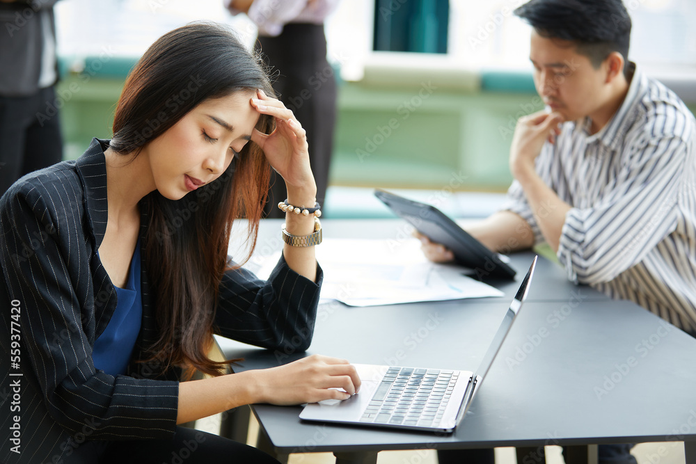 businesswoman feeling tired from overworked with laptop computer on the table businesswoman feeling tired from overworked with laptop computer on the table