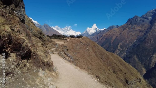 Namche Bazaar, Nepal: Point of view footage of an hiker walking the trail toward Everest base camp between Pangboche and Namche Bazaar with view of Mt Everest and Ama Dablam peaks in the Himalayas photo