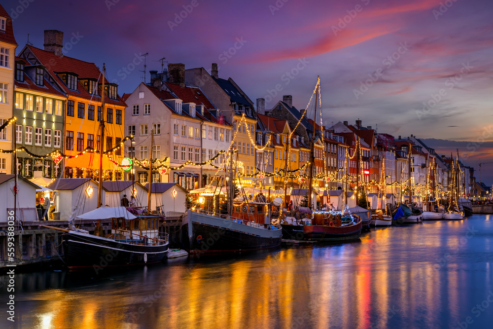 Beautiful winter sunset view of the popular Nyhavn area at Copenhagen, Denmark, decorated for Christmas - obrazy, fototapety, plakaty 