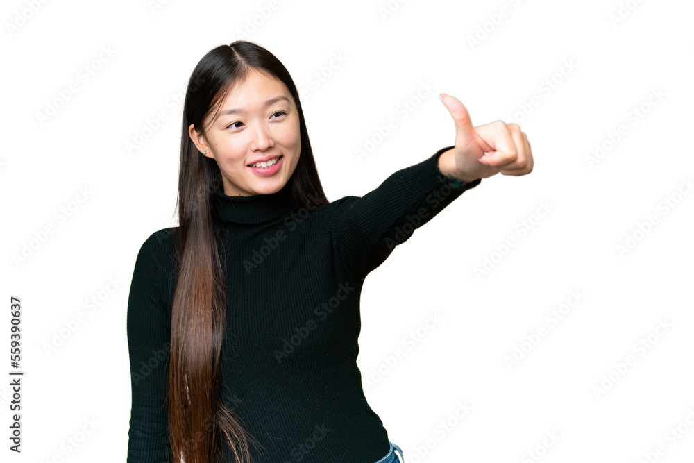 Young Asian woman over isolated chroma key background giving a thumbs up gesture Young Asian woman over isolated chroma key background giving a thumbs up gesture
