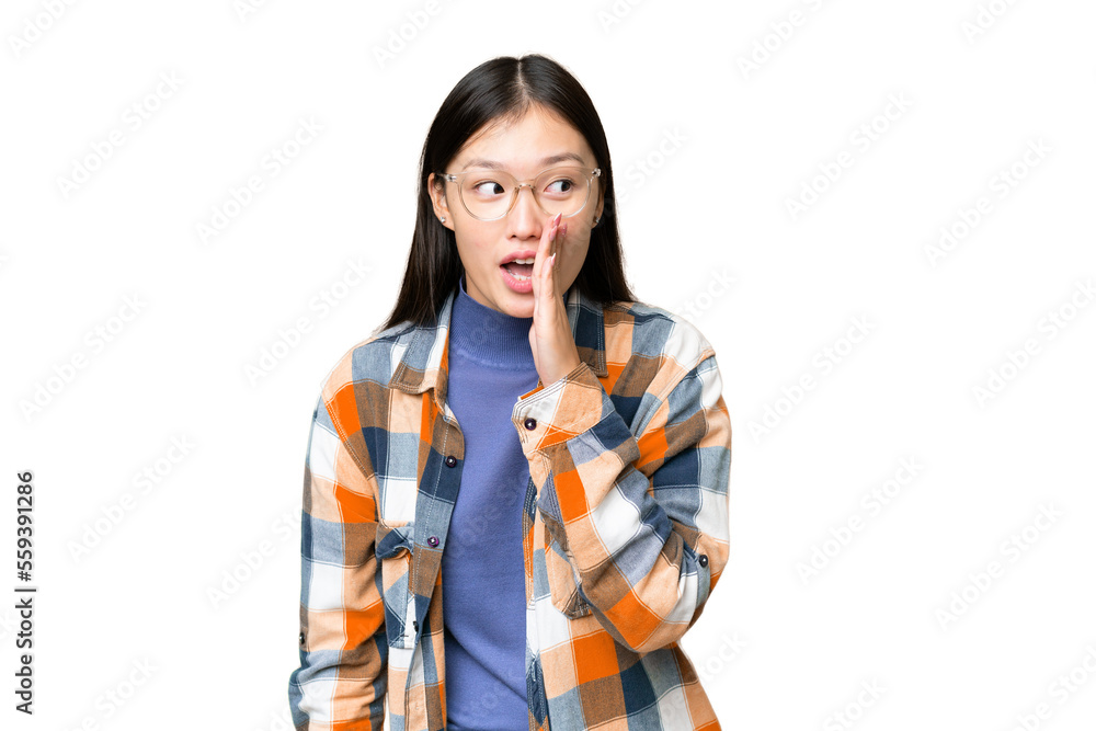 Young Asian woman over isolated chroma key background whispering something with surprise gesture while looking to the side Young Asian woman over isolated chroma key background whispering something with surprise gesture while looking to the side
