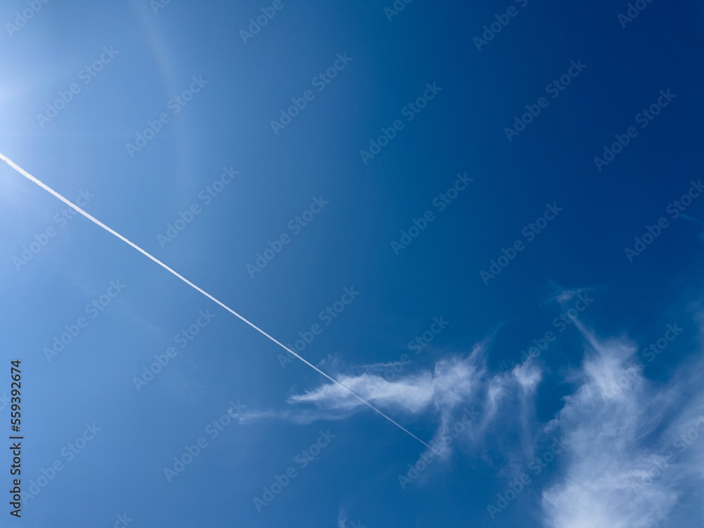 Contrails breaking through the summer blue sky Contrails breaking through the summer blue sky