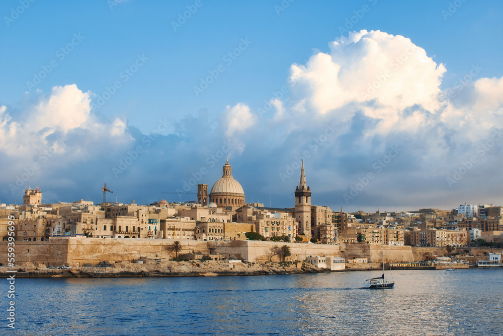 Valletta city skyline with a blue sky with big fluffy dramatic clouds in the background