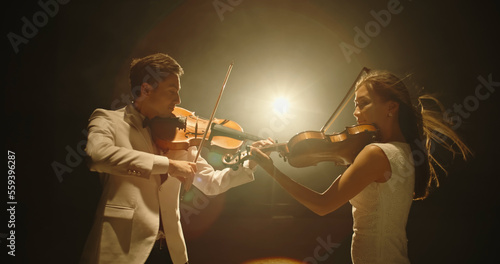 Canvas Print Duet of two professional violin players having a solo together, performing on st