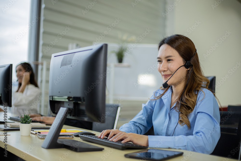 Asian telemarketing agent in call center office Asian telemarketing agent in call center office