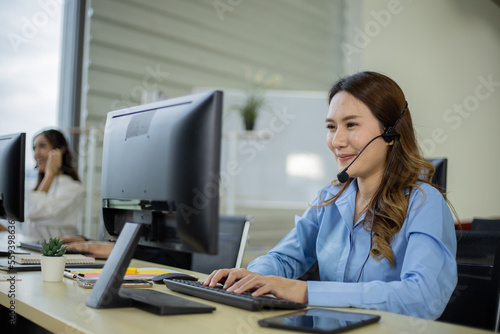 Obraz na plátně Asian telemarketing agent in call center office