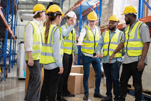Photography Diversity group of worker in warehouse stand round hand gathering boost up team