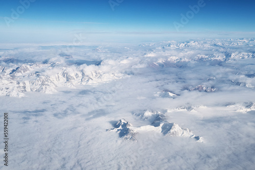 Mountain range and white clouds in blue sky at day.