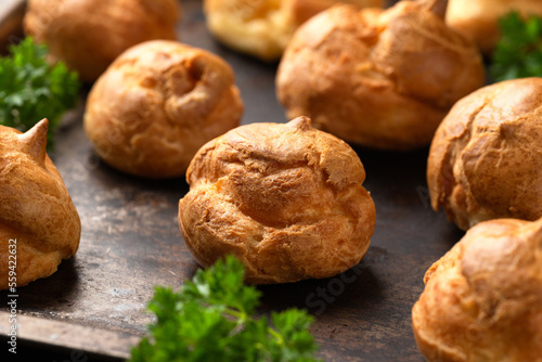 Savoury profiteroles stuffed with Molten cheddar cheese sauce, party food concept