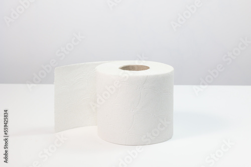 Close up Single roll of 100% recycled toilet paper, isolated o white background, copy space.