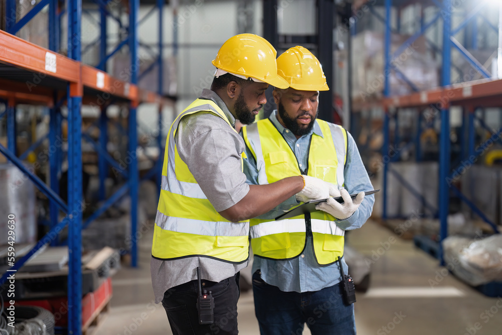 African american working in warehouse check forklift truck loading carton box smile check hand African american working in warehouse check forklift truck loading carton box smile check hand