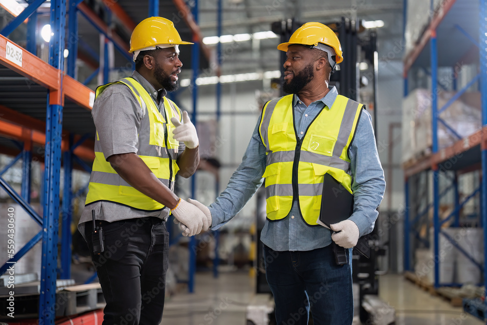 African american working in warehouse check forklift truck loading carton box smile check hand African american working in warehouse check forklift truck loading carton box smile check hand