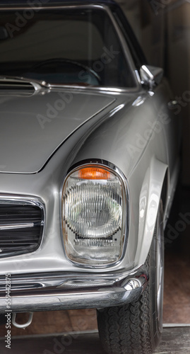 Partial view of a silver, well-known and popular sporty roadster from Germany from the 60s and 70s © A.Freund