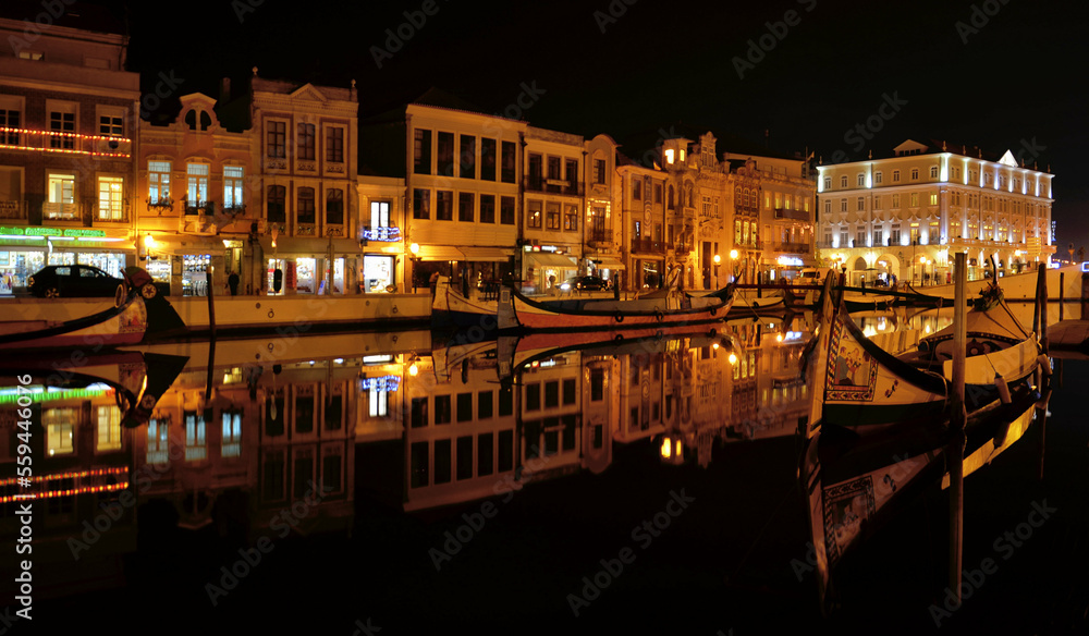 Night photos of the main city canal in Aveiro with traditional boats, Portugal