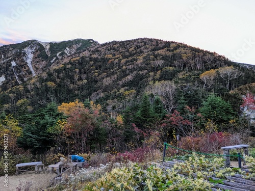 In front of Kosumo Hut in October, colored Mt. Kosumo. Okuwa Village, Nagano Prefecture, Japan photo