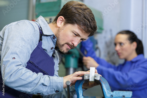 male and female workers at industrial factory