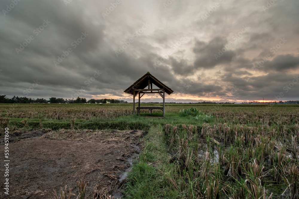Sunset on a cloudy sky, Hut with windblown clouds in the background, Long Exposure Sunset on a cloudy sky, Hut with windblown clouds in the background, Long Exposure